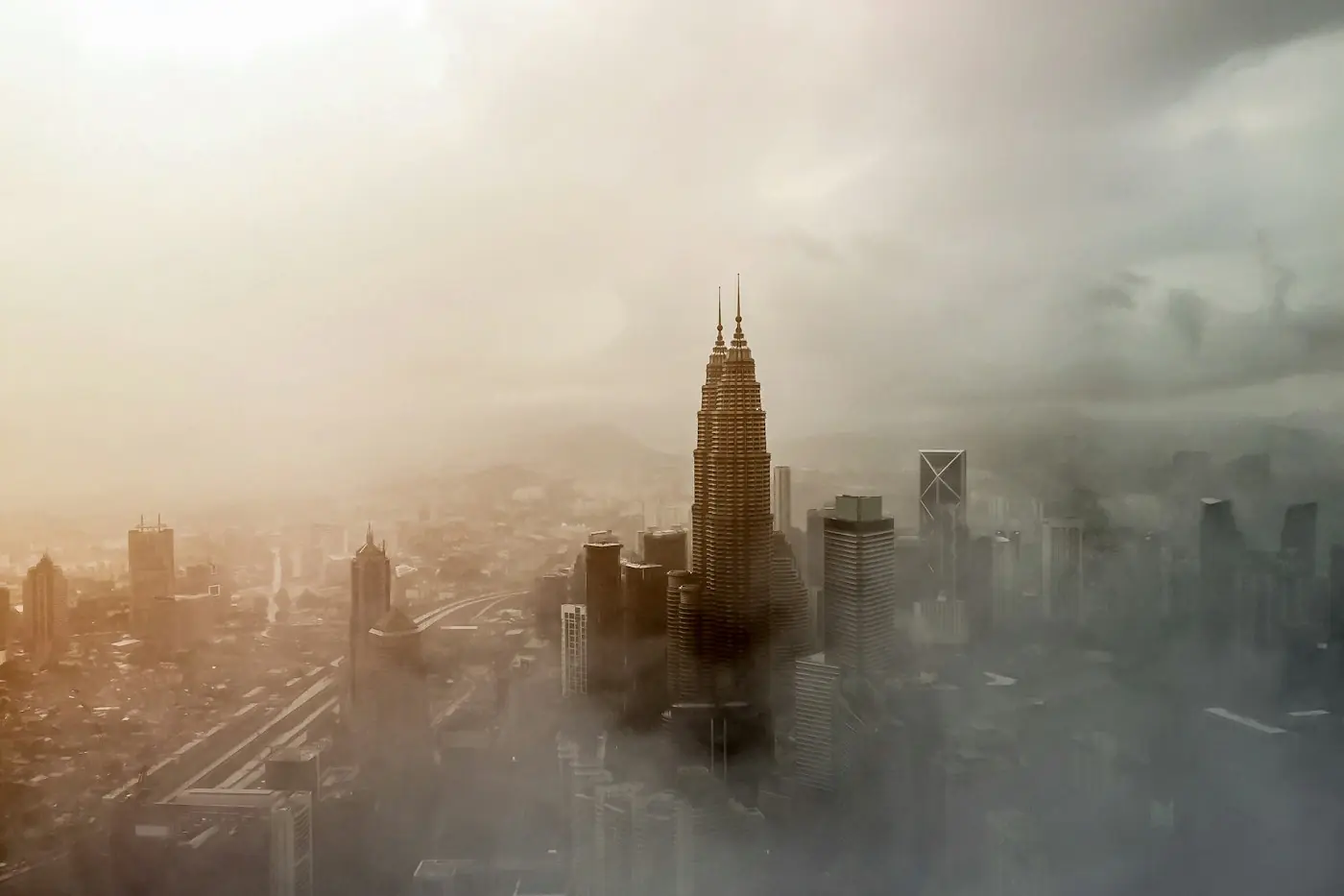 The Kuala Lumpur skyline and Petronas Twin Towers rising above morning mist